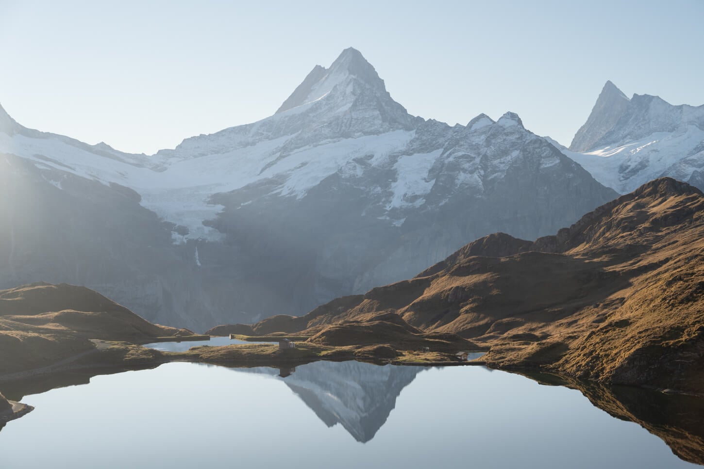 Schreckhorn's summit reflecting in the waters of lake Bachalpsee at Sunrise.