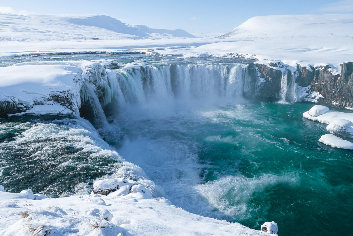 North Iceland waterfall covered in snow