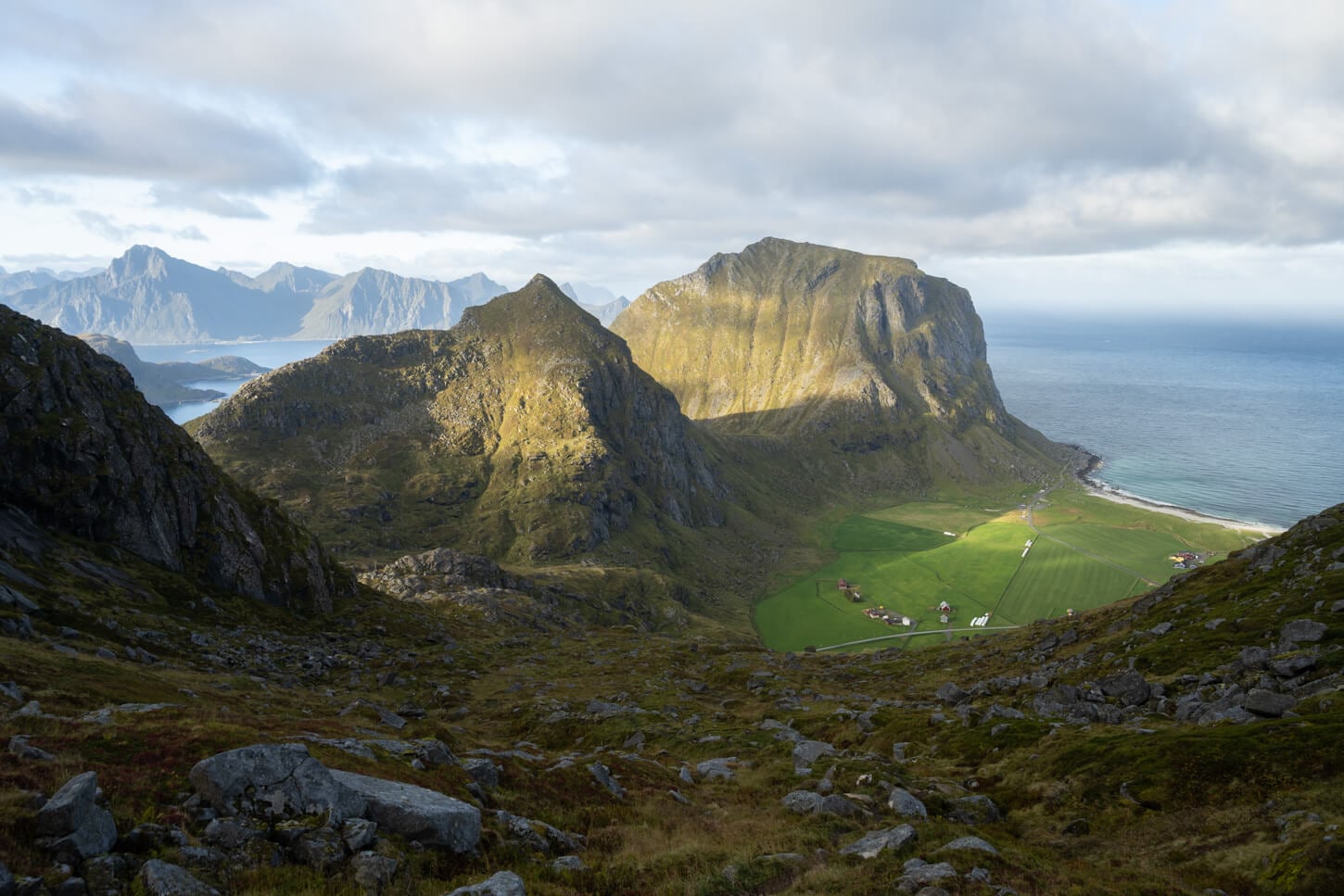 View of Uttakleiv Bech from Himmeltinden with Mannen and Veggen towering above the beach.