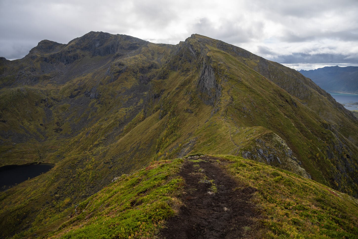 View of a mountain ridge in the Lofoten Island, with mountains covered in green grass and moss