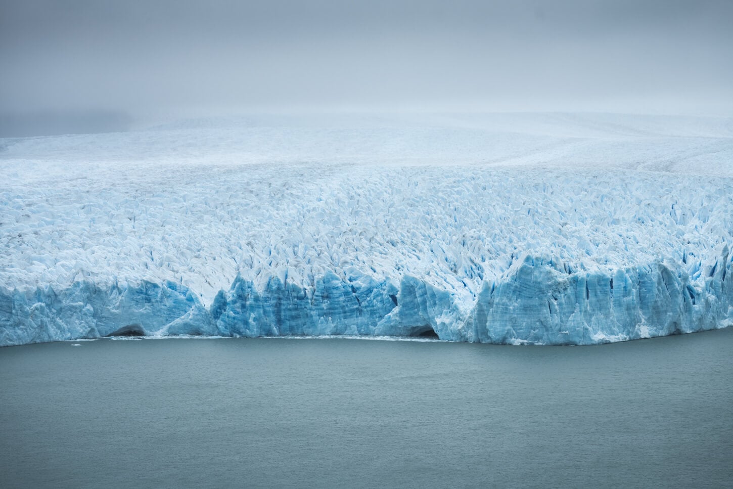 Detail of Perito Moreno's receding glaciers far out in the ater, showing its jagged edges.