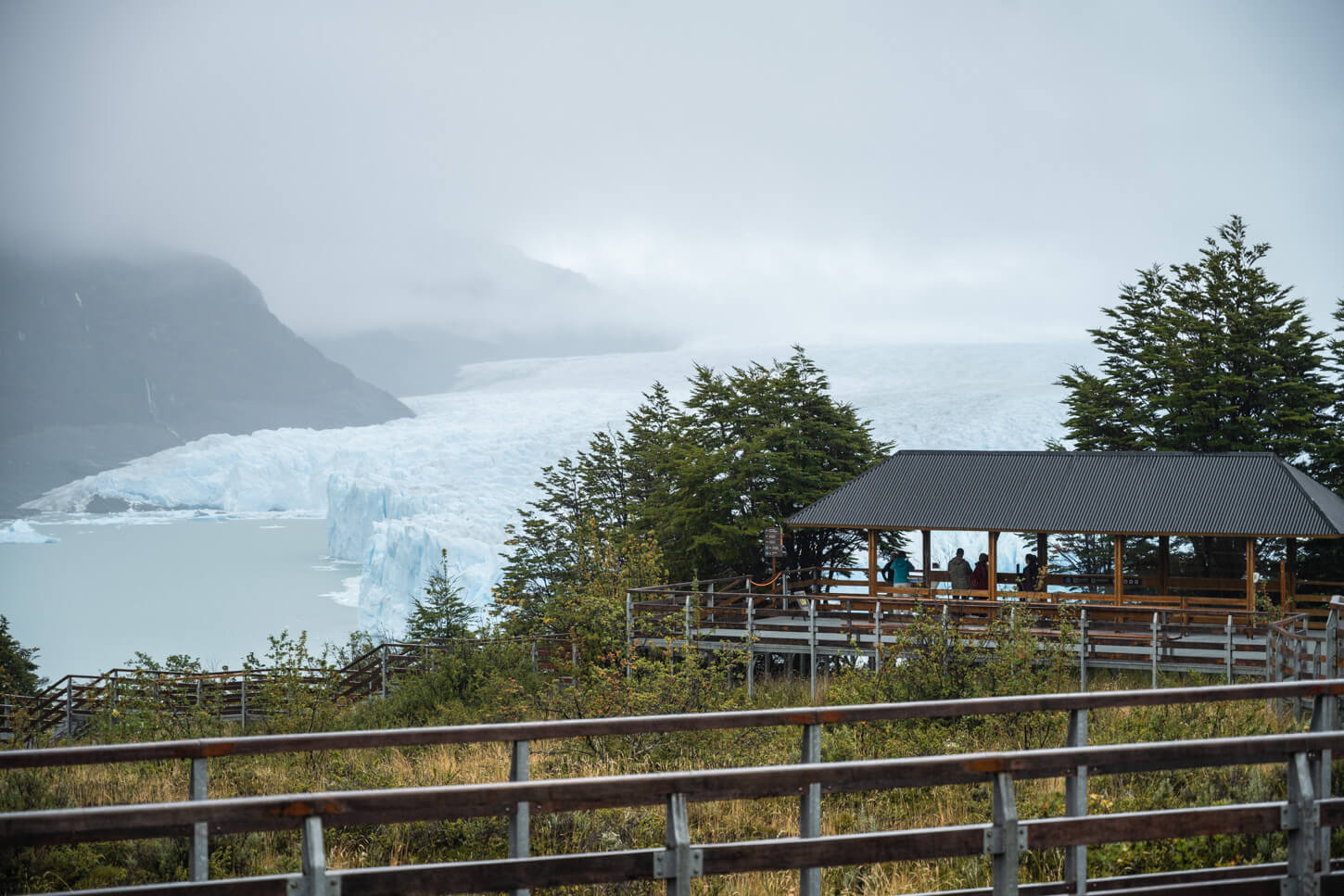 View of the perito moreno walkways with a covered area on them, and the glacier in the background,