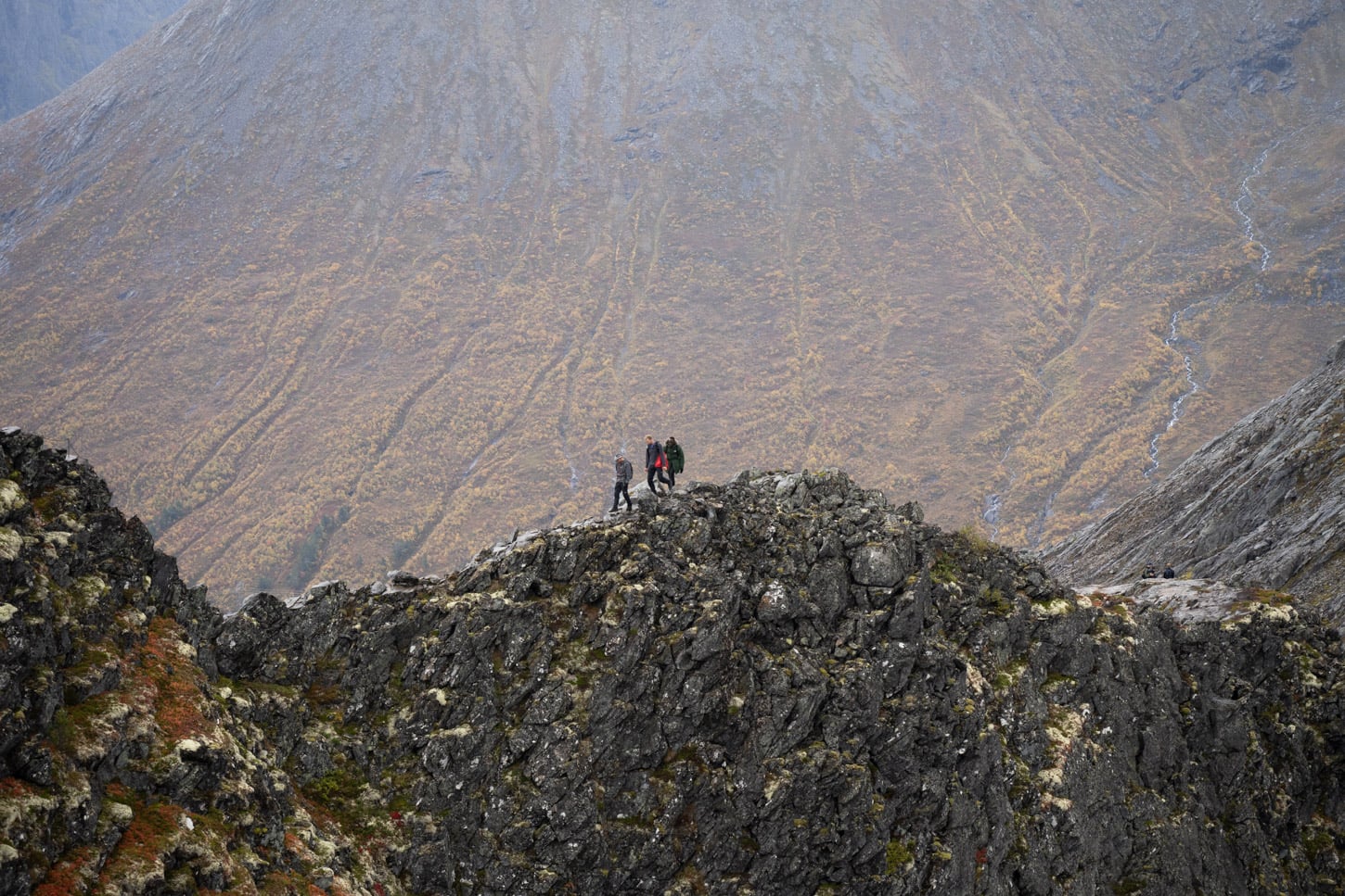 Hikers walking on an xposed ridge ar romsdalseggen