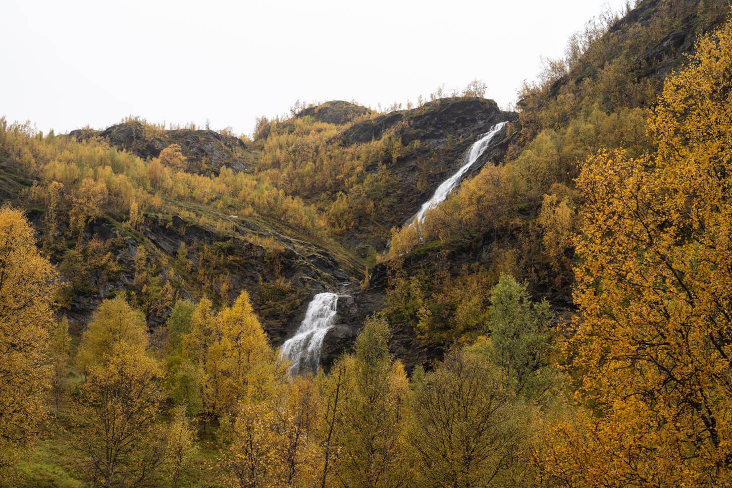 Two steps of the waterfall Rottenvikfossen viewed from the trail
